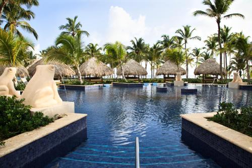 a pool at a resort with palm trees at Barceló Bávaro Palace All Inclusive in Punta Cana