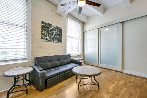 a living room with a couch and two tables at Spacious Condos Steps Away from French Quarter in New Orleans