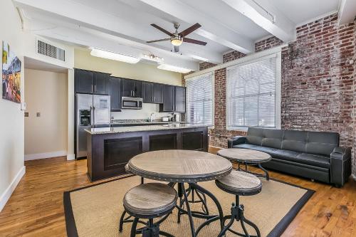 a living room with a table and chairs and a couch at Spacious Condos Steps Away from French Quarter in New Orleans