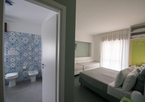 A bed or beds in a room at Oikos Selinunte Guest House