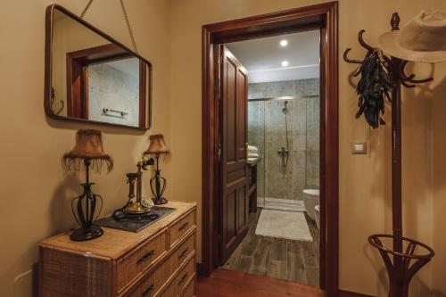 a bathroom with a mirror and a sink and a toilet at Finca Santa Maria in Callao Salvaje