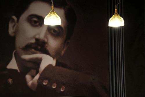a man with a moustache in front of a mirror at Hotel Litteraire Le Swann, BW Premier Collection in Paris