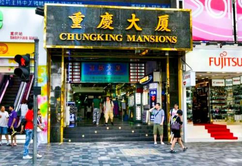 a group of people walking in front of a shopping mall at Holiday Guest House in Hong Kong