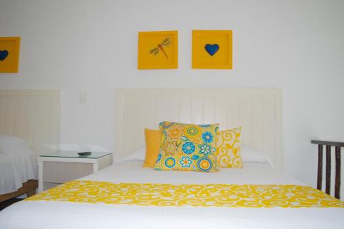 a bedroom with a bed with two pictures on the wall at BSEA Cancun Plaza Hotel in Cancún