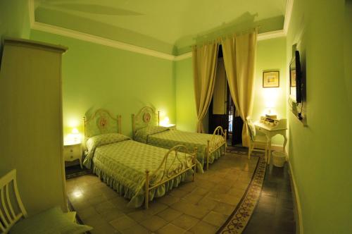 Ένα ή περισσότερα κρεβάτια σε δωμάτιο στο Al Duomo Inn
