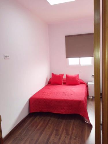 Un ou plusieurs lits dans un hébergement de l'établissement Apartamentos cerca del Aeropuerto