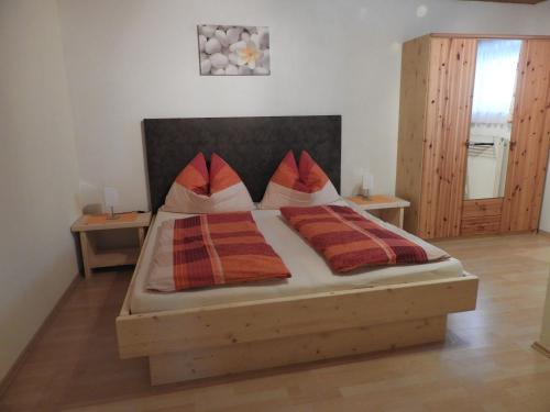a bedroom with a bed with two pillows on it at Kleinwidmoos-Apartment in Wagrain