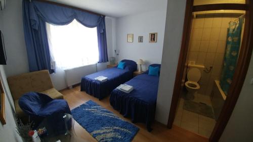 a living room with two beds and a window at Vila San in Banja Luka