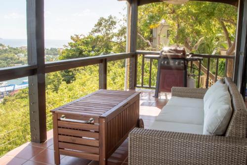 a living room with a couch and a table on a balcony at Marina Vista St. Thomas in St Thomas