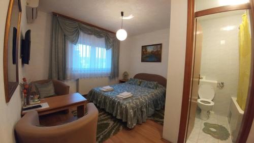 a small room with a bed and a bathroom at Vila San in Banja Luka