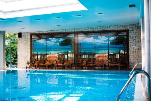 a swimming pool with chairs and a view of the ocean at Hemus Hotel - Vratza in Vratsa