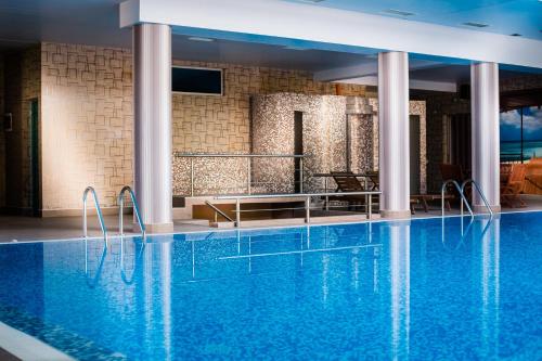 a hotel swimming pool with blue water in a building at Hemus Hotel - Vratza in Vratsa