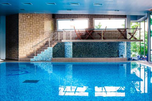 a swimming pool with a staircase in a building at Hemus Hotel - Vratza in Vratsa