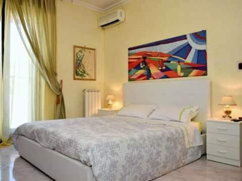 San DonaciにあるB&B Caravaggioのベッドルーム1室(ベッド1台付)が備わります。壁には絵画が飾られています。
