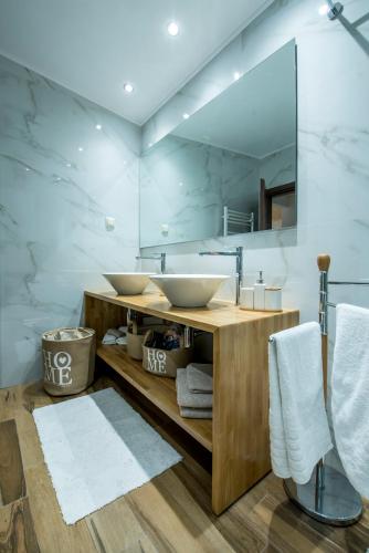 a bathroom with two sinks and a mirror at Las Palmas in Kavála