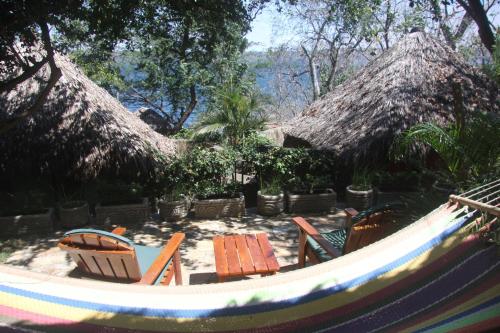 a group of chairs and tables in a hammock at San Simian Lodge in La Laguna