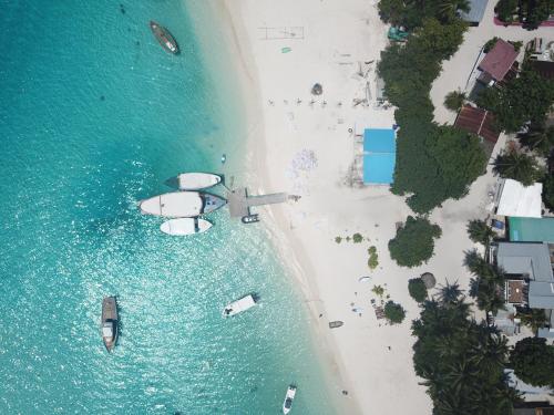 an aerial view of a beach with boats in the water at Seena Inn in Fulidhoo