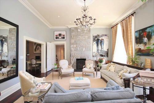 a living room filled with furniture and a large window at All Suites Whitney Manor in Kingston