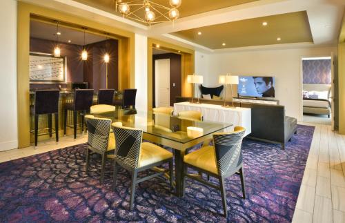 a dining room with a table and chairs and a living room at The Guest House at Graceland in Memphis