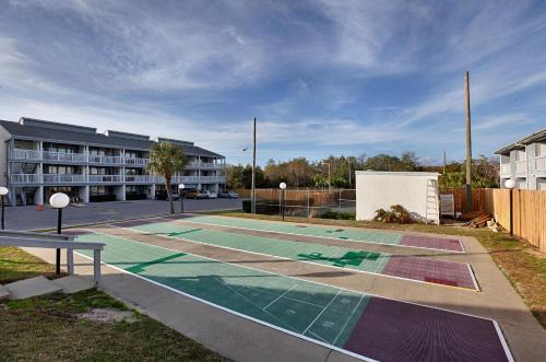 a tennis court in front of a apartment complex at Southwind by Panhandle Getaways in Panama City Beach