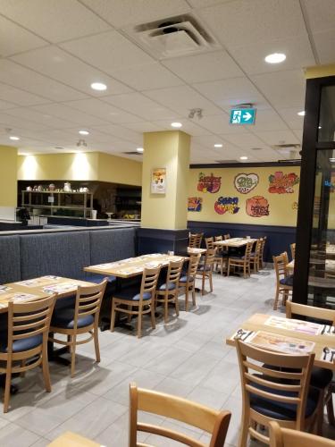 a dining room with tables and chairs in a restaurant at Days Inn by Wyndham Edmonton Downtown in Edmonton