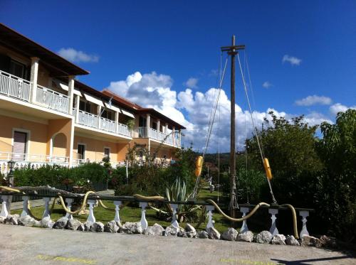 a boat on display in front of a building at Eleni Apartments in Arillas