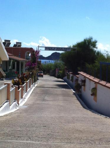 an empty street with a car driving down the road at Eleni Apartments in Arillas