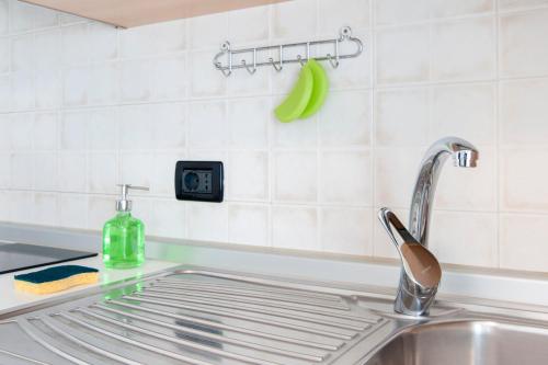 a kitchen sink with a faucet and a green banana at Residence Cigno in Rimini