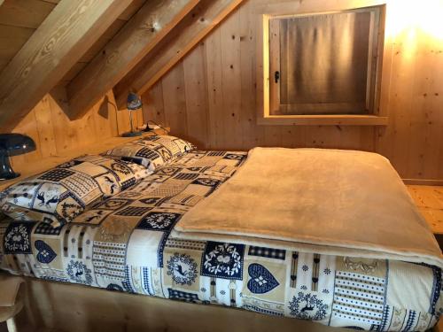 a bed in a room in a log cabin at Alpine Chalet in Santa Caterina Valfurva