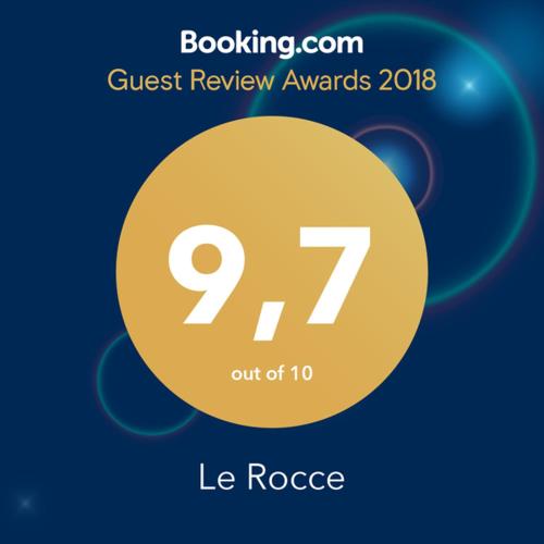 a sign that reads guest review awards with a yellow circle at Le Rocce in SantʼAgata deʼ Goti