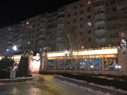 a building with christmas lights in a city at night at Strada 25 Octombrie in Tiraspol