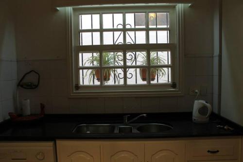 a kitchen with a sink and a window at GM Rooms Boutique Hotel in La Rioja