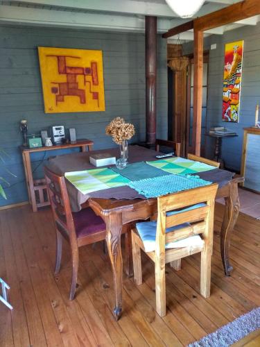 a dining room table with chairs and a table and a table and chairsktop at Ecolodge Lanalhue Hostel in Cañete