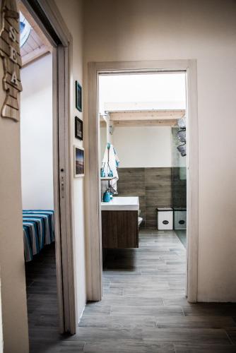 a hallway leading to a bathroom with a sink at Mediterranean house in SantʼAntìoco