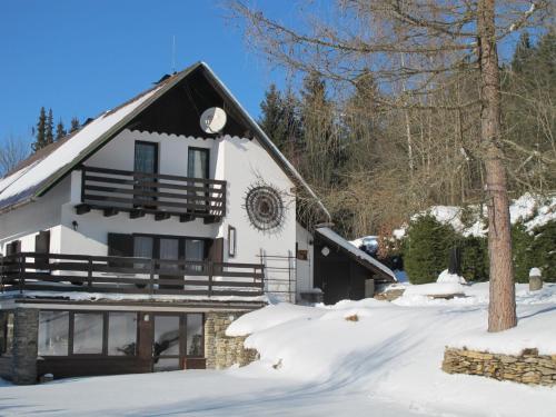 a white house with snow on the ground at Holiday home in Cachrov - Böhmerwald 35500 in Čachrov