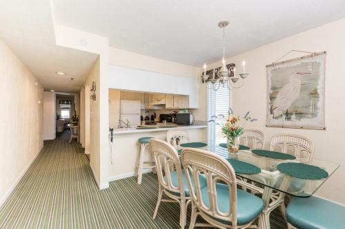 a dining room and kitchen with a table and chairs at Windy Shores II in Myrtle Beach