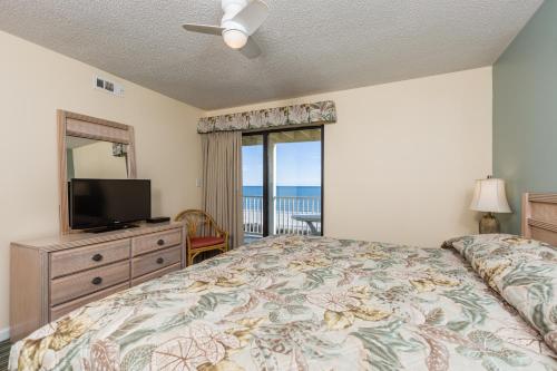 a bedroom with a bed and a flat screen tv at Windy Shores II in Myrtle Beach