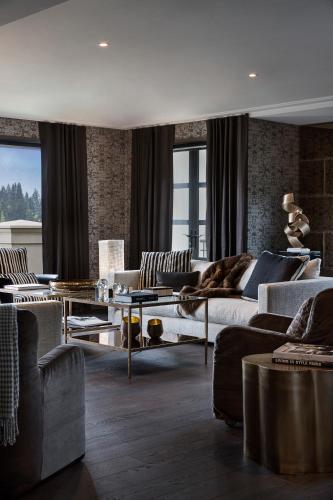a large living room with couches and a table at Sofitel Queenstown Hotel & Spa in Queenstown