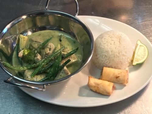 a plate of food with a pot of soup and rice at The Kings Head in New Buckenham