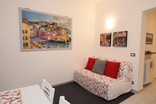 een woonkamer met een bank en een schilderij aan de muur bij A due passi dalla LANTERNA in Genua