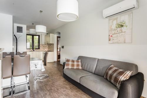 a living room with a couch and a kitchen at Keystone Apartments in Donji Morinj