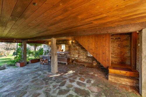 a house with a wooden ceiling and a stone floor at Loft Caminha in Caminha