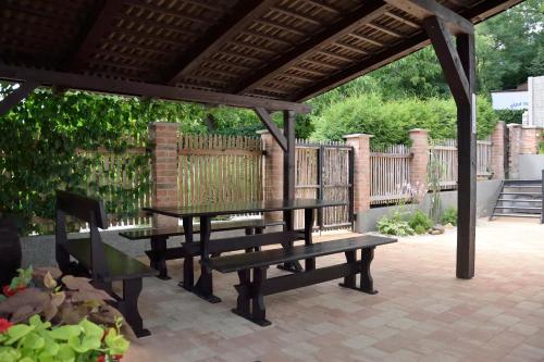 a picnic table and benches on a patio at Ubytování U Sklepů in Kyjov