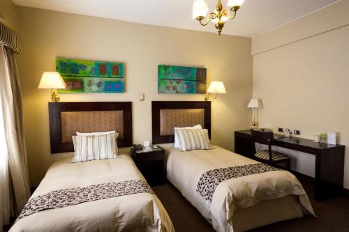 A bed or beds in a room at Costa del Sol Wyndham Cajamarca