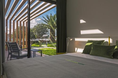 a bedroom with a bed and a large window at Quinta do Passo in Ribeira Grande