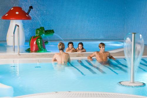a group of people in a swimming pool at Apartamentos Spa Villa Pasiega in Hoznayo