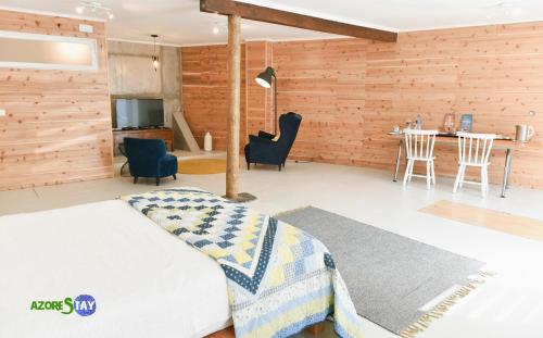 a bedroom with a bed and a table and chairs at AZORESTAY in Horta