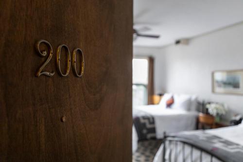 a bedroom with a door with the number at Hotel Congress in Tucson