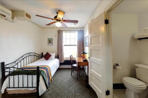 a bedroom with a bed and a ceiling fan at Hotel Congress in Tucson