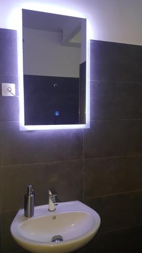 a bathroom with a sink and a mirror at Mirador Balaton design Villa in Balatonakarattya